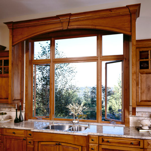 windows above a kitchen sink with view of trees