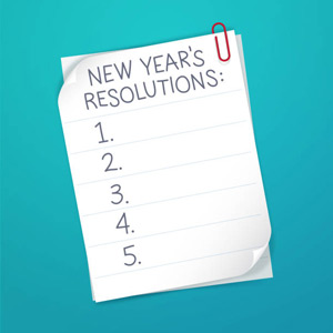 papers in paperclip with New Year's Resolutions text