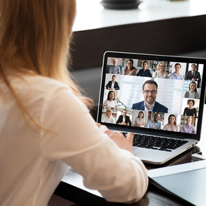person sitting in front of a laptop in a virtual meeting