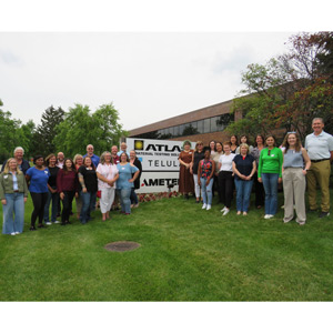 FGIA group photo outside Atlas facility next to sign