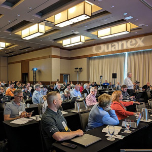 attendees in a meeting room at an FGIA event showing a sponsor logo projected on the wall