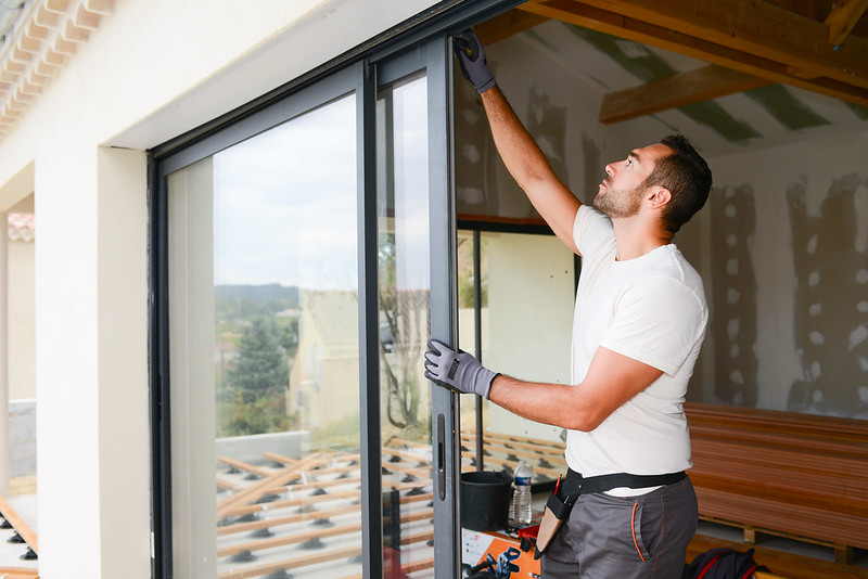Man installing a glass door