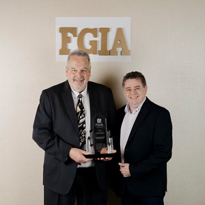 Man receiving an award at the FGIA Annual Conference