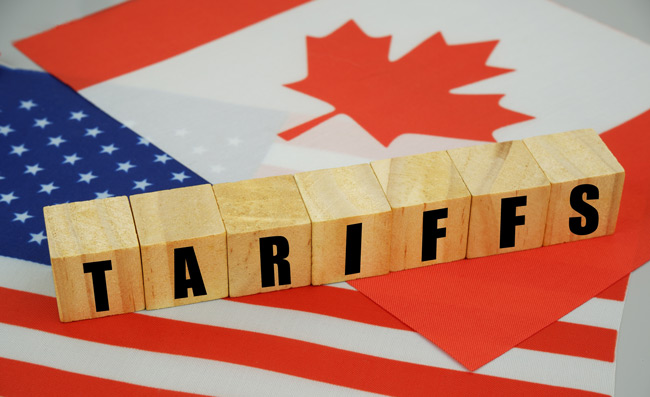 US and Canadian flags with letter blocks that spell tariffs